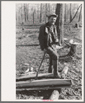 Farmer of Chicot Farms, Arkansas resting after chopping wood