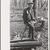 Farmer of Chicot Farms, Arkansas resting after chopping wood