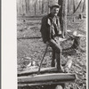 Farmer of Chicot Farms, Arkansas resting after chopping wood