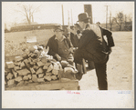 Man talking to farmer with truckload of wood, Laurel, Mississippi