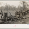 Farmers of Chicot Farms Project, Arkansas with mud sled which is used for transporting supplies