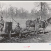 Farmers of Chicot Farms Project, Arkansas with mud sled which is used for transporting supplies