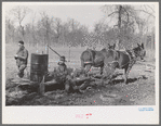 Farmers of Chicot Farms Project, Arkansas with mud sled which is used for transporting supplies