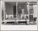 Husband and wife on porch of home, Chicot Farms, Arkansas