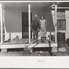 Husband and wife on porch of home, Chicot Farms, Arkansas