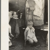 Child of white migrant worker in front of trailer home, Weslaco, Texas