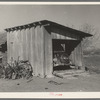 Garage and automobile of small vegetable farmer near Santa Maria, Texas. This farmer said that he found Mexican labor satisfactory. He indicated that the white farmers in this section felt a definite responsibility to the Mexican and saw that he was cared