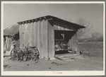 Garage and automobile of small vegetable farmer near Santa Maria, Texas. This farmer said that he found Mexican labor satisfactory. He indicated that the white farmers in this section felt a definite responsibility to the Mexican and saw that he was cared