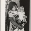 Mexican girl with baby sister in front of hut near Santa Maria, Texas