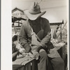 Removing outer leaves from cabbages before packing, Alamo, Texas