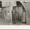Negro residents of Mound Bayou, Mississippi in front of restaurant, former theater