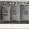 Chicken feed, flour and other bulky products are now bagged in printed cotton materials for use as dress materials. Mercedes, Texas