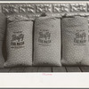 Chicken feed, flour and other bulky products are now bagged in printed cotton materials for use as dress materials. Mercedes, Texas