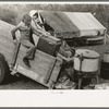 Unloading household goods from trailer in process of setting up camp near Harlingen, Texas