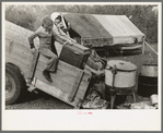 Unloading household goods from trailer in process of setting up camp near Harlingen, Texas