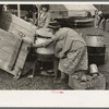 Unloading household goods from trailer in process of setting up camp near Harlingen, Texas