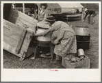 Unloading household goods from trailer in process of setting up camp near Harlingen, Texas