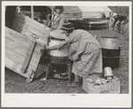 Unloading household goods from trailer in process of setting up camp near Harlingen, Texas