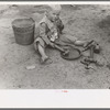 Child of white migrant worker playing with automobile tools near Harlingen, Texas