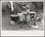 Child of white migrant worker ironing in camp near Harlingen, Texas