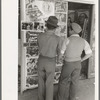 Mexican boys looking at movie poster, San Antonio, Texas