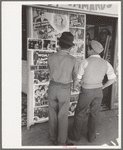 Mexican boys looking at movie poster, San Antonio, Texas