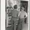 Mexican boys looking at movie poster, San Antonio, Texas