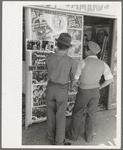Mexican boys looking at movie poster, San Antonio, Texas