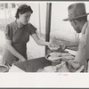 Preparing plates of tortillas and fried beans to sell to pecan shellers, San Antonio, Texas