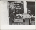Woman in front of secondhand furniture store, San Antonio, Texas