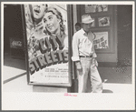 Mexican man in front of movie theater, San Antonio, Texas