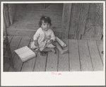 Mexican child on porch of house facing corral, San Antonio, Texas