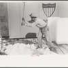 Breaking ice with flat side of ax, La Pryor, Texas