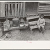 Mexican boy sitting on door step, San Antonio, Texas