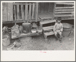 Mexican boy sitting on door step, San Antonio, Texas