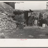 Unemployed workers in front of a shack with Christmas tree, East 12th Street, New York City