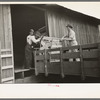 Southeast Missouri Farms. Loading cook stove on to truck for transporting to new farm unit