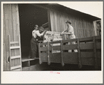 Southeast Missouri Farms. Loading cook stove on to truck for transporting to new farm unit