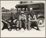 Farmers sitting on running board of car at liquid feed loading station, Owensboro, Kentucky