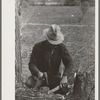 White migrant making stakes for setting up his tent near Harlingen, Texas