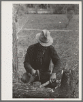 White migrant making stakes for setting up his tent near Harlingen, Texas