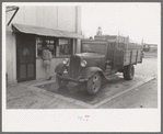 Crates of sweet potatoes being weighed at starch plant, Laurel, Mississippi