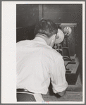 Chemist running test on sweet potato starch, Laurel, Mississippi