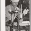 Chemist running test on sweet potato starch, Laurel, Mississippi