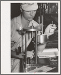 Chemist running test on sweet potato starch, Laurel, Mississippi