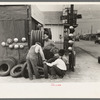 Group of men inspecting secondhand tires for sale, Corpus Christi, Texas