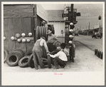 Group of men inspecting secondhand tires for sale, Corpus Christi, Texas