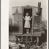 Daughter of migrant in doorway of trailer, Sebastian, Texas