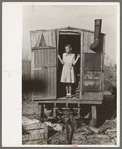 Daughter of migrant in doorway of trailer, Sebastian, Texas