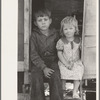 Children of migrants sitting in doorway of trailer, Edinburg, Texas